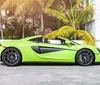 A bright green sports car with its doors open upwards is parked with a backdrop of high-rise buildings under a blue sky