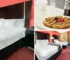 The image shows a neatly arranged hotel room with two queen-sized beds featuring a red and black color scheme and a striped carpet