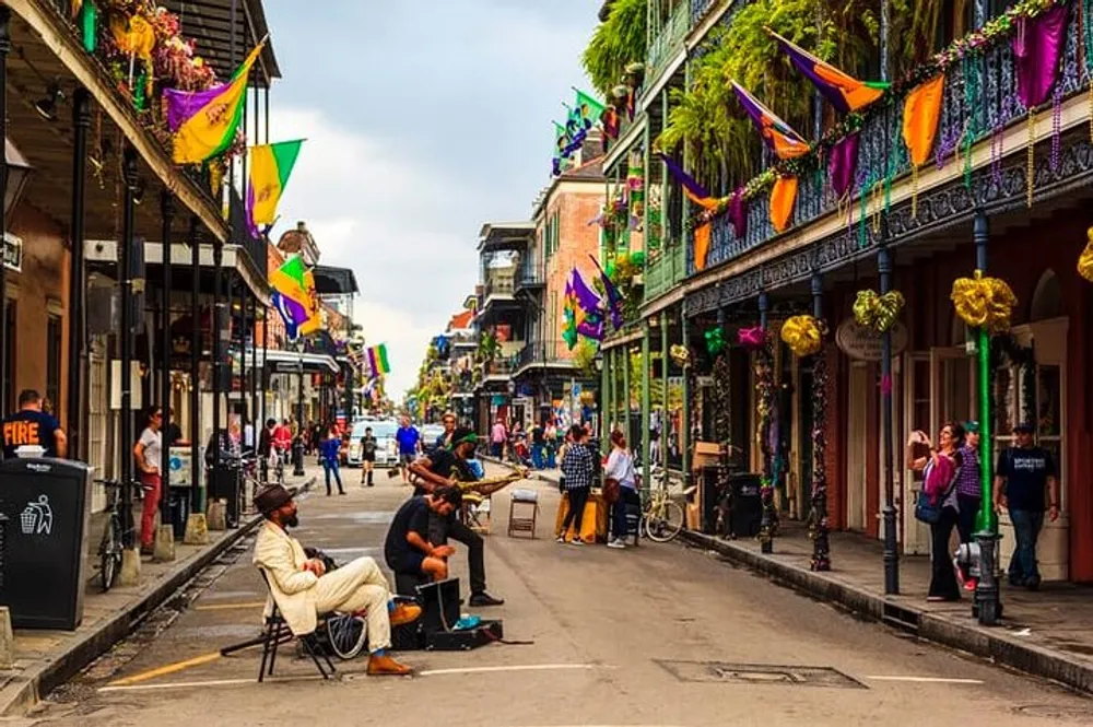 This image depicts a lively street scene possibly in New Orleans with colorful Mardi Gras decorations musicians performing on a sidewalk and people casually enjoying the vibrant atmosphere