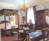 The image shows a Victorian-style bedroom with antique furniture ornate decorations and is cordoned off suggesting it might be part of a museum or historic home tour