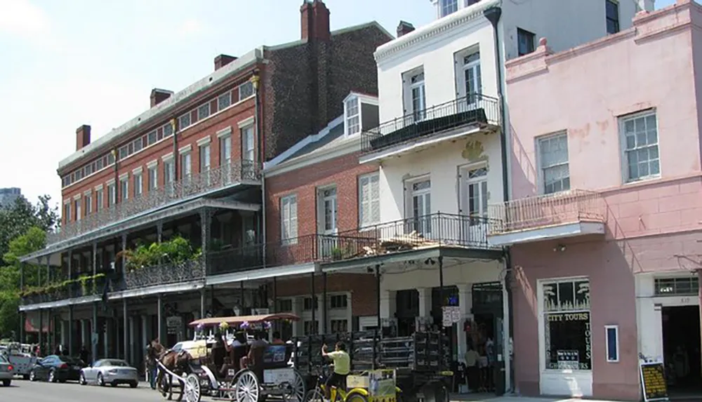 The image shows a street view with traditional buildings featuring balconies with iron railings and a horse-drawn carriage resembling a scene from the French Quarter in New Orleans