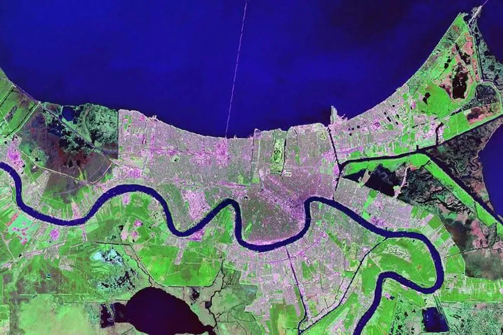 This image depicts an area with a prominent winding river cutting through a patchwork landscape of urban development and green spaces presented in enhanced unnatural colors likely indicating a satellite or infrared view