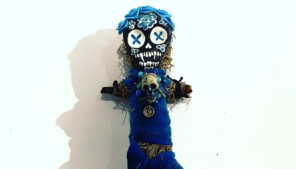 The image shows a colorful decorated skeletal figure that could be associated with a Day of the Dead celebration