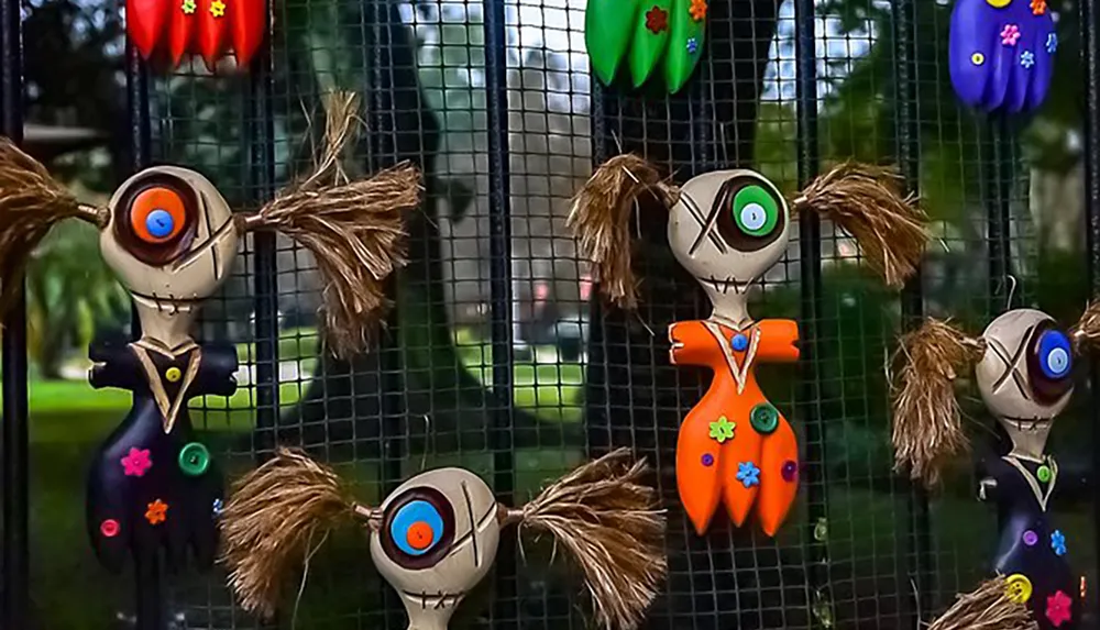 The image features a collection of whimsical stylized dolls with button eyes and stitched features reminiscent of characters from a Tim Burton film displayed against a mesh background