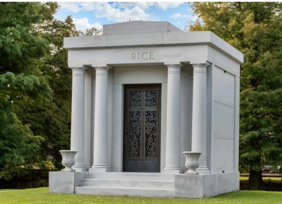 The image shows a stately white mausoleum with the name RICE inscribed above the entrance, flanked by classical columns and set against a backdrop of green trees.