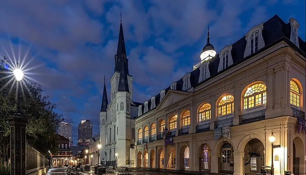 The image captures a serene twilight scene of the historic New Orleans Jackson Square with the iconic St Louis Cathedral and the Louisiana State Museums Cabildo building