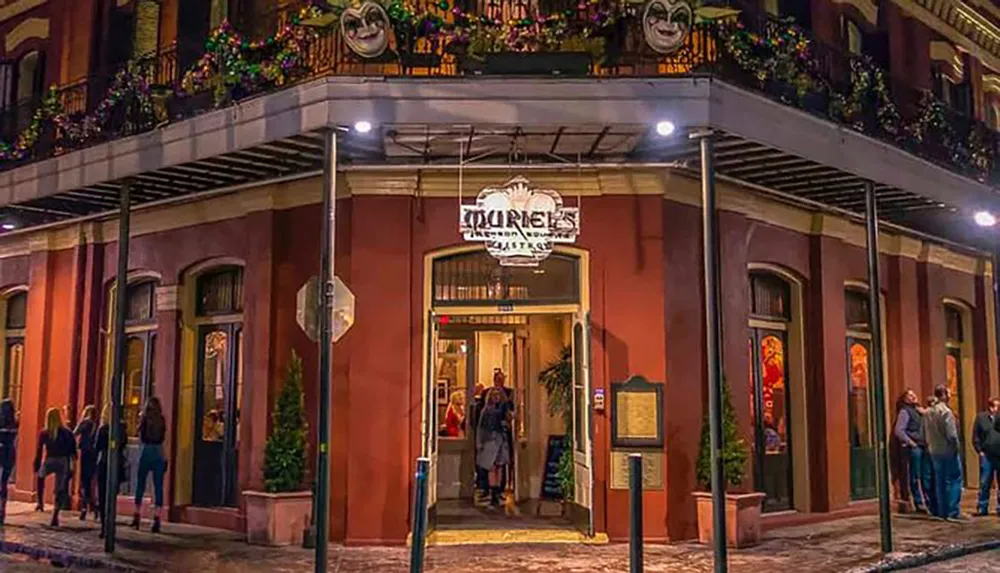 The image depicts the lively entrance to Tujagues a restaurant and bistro in New Orleans adorned with Mardi Gras masks and vibrant dcor reflecting the citys festive atmosphere