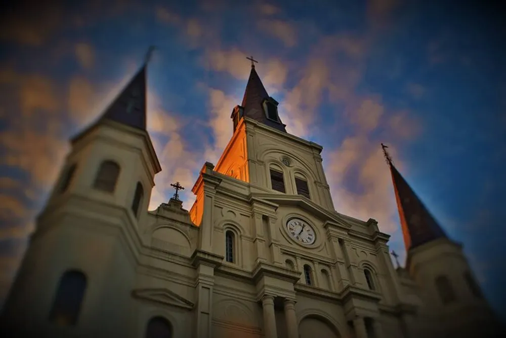 The image showcases a grand church with twin spires and a glowing cross captured at dusk against a softly clouded sky