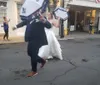 A joyful bride and groom are participating in a lively second line parade a traditional New Orleans celebratory procession with umbrellas in hand