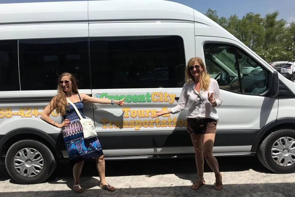 Two individuals are posing and smiling in front of a van marked Crescent City Tours  Transportation