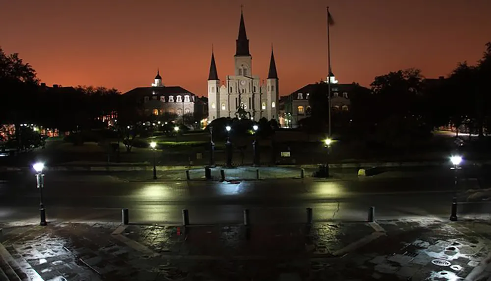 The image captures a serene night scene of Jackson Square with the iconic illuminated St Louis Cathedral in New Orleans under a twilight sky