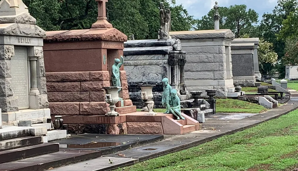 The image shows a historic cemetery with ornate mausoleums and statues highlighting the elaborate and commemorative art typical of certain graveyards