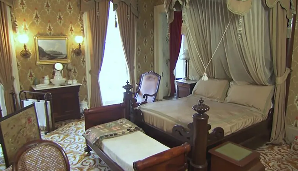The image shows an ornate Victorian-style bedroom with rich patterns heavy drapery antique furniture and a canopied bed