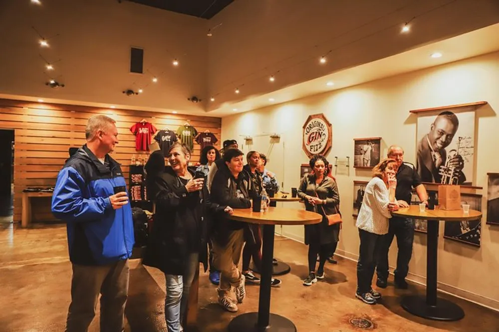 A group of people are enjoying a tasting experience at a distillery or brewery with a smiling woman holding up her glass in the foreground