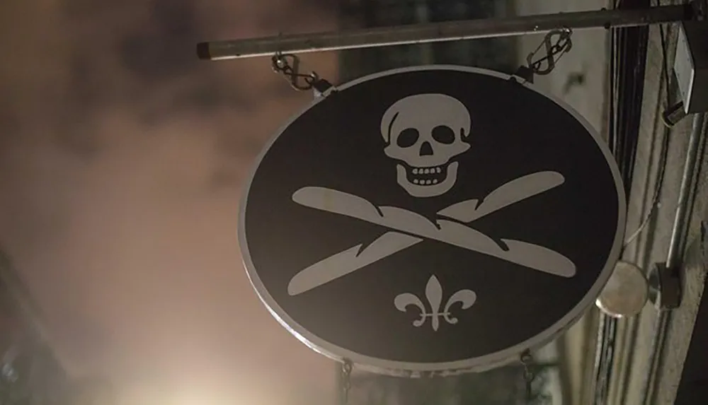 A hanging signboard features a skull and crossed bones symbol with a fleur-de-lis suggesting a theme of piracy or danger