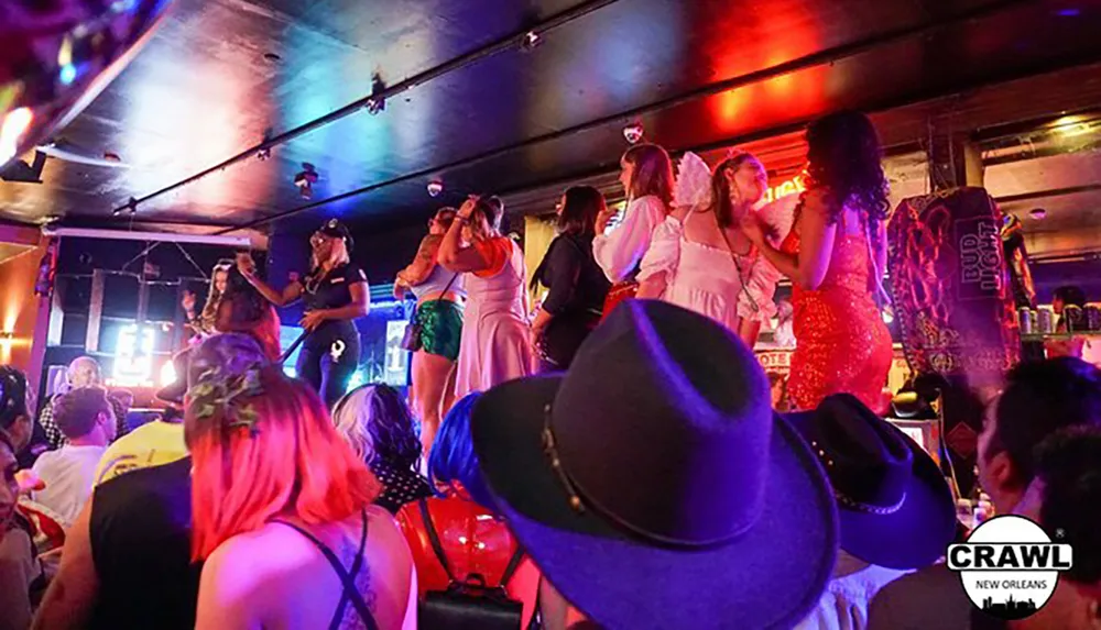 A lively bar scene with people dancing on the bar counter under colorful lights