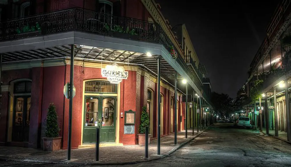 The image shows a quiet atmospheric street at night with a corner building prominently displaying a sign that reads Douriean suggesting a boutique or gallery in an area with a New Orleans French Quarter-like charm