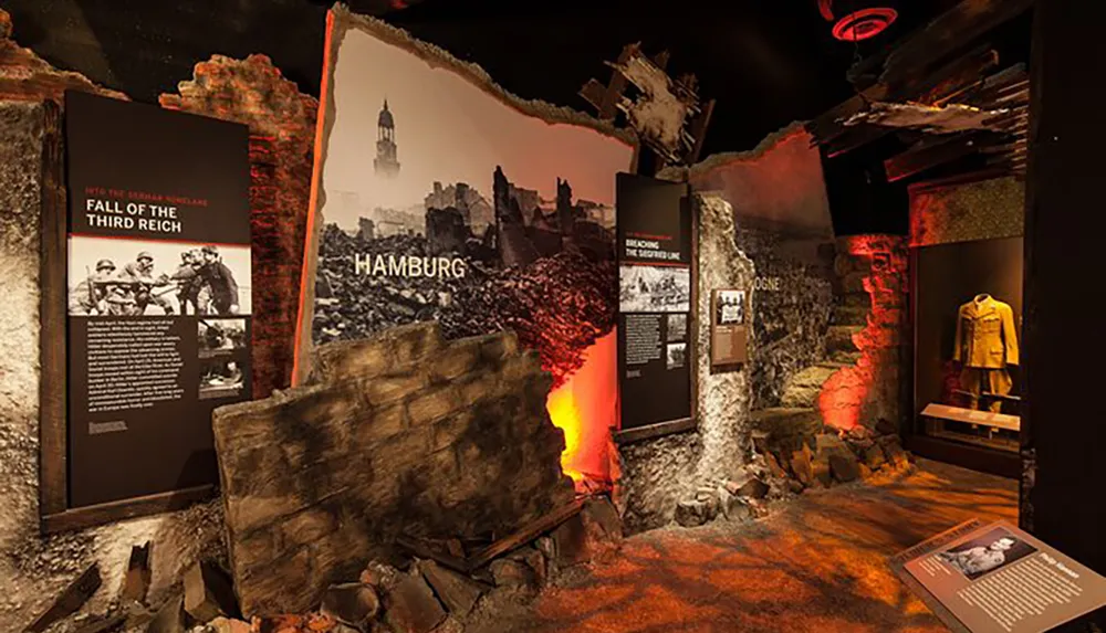 The image shows an immersive museum exhibit focusing on the destruction of Hamburg and the fall of the Third Reich with information panels artifacts and dramatic lighting to evoke the atmosphere of a bombed cityscape