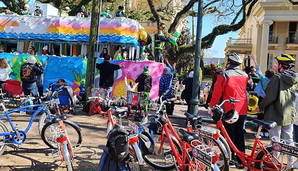A vibrant outdoor scene with a colorful parade float spectators enjoying the festivities and a foreground of parked bicycles
