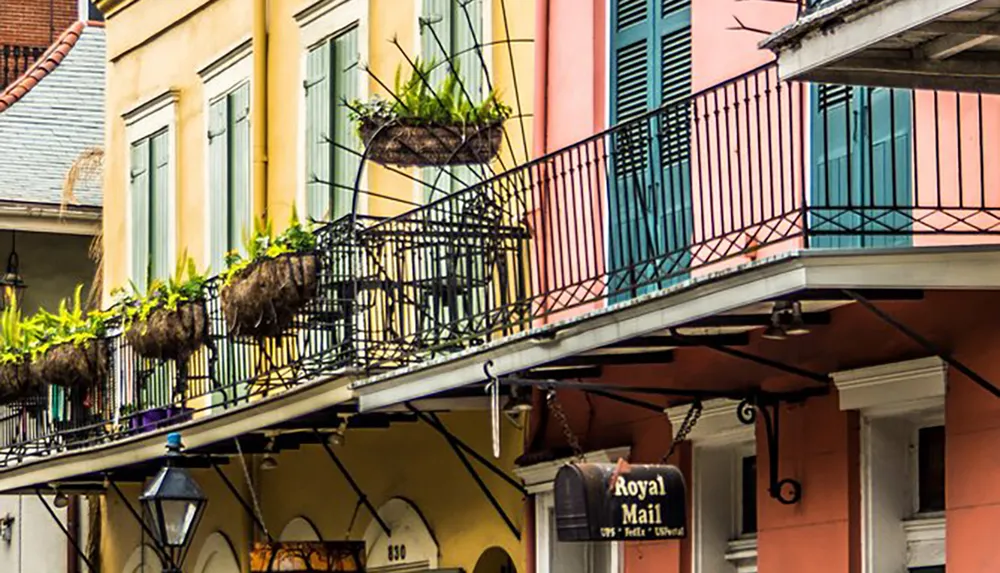 The image showcases the colorful facades and wrought-iron balconies typical of the French Quarter in New Orleans along with a sign that reads Royal Mail
