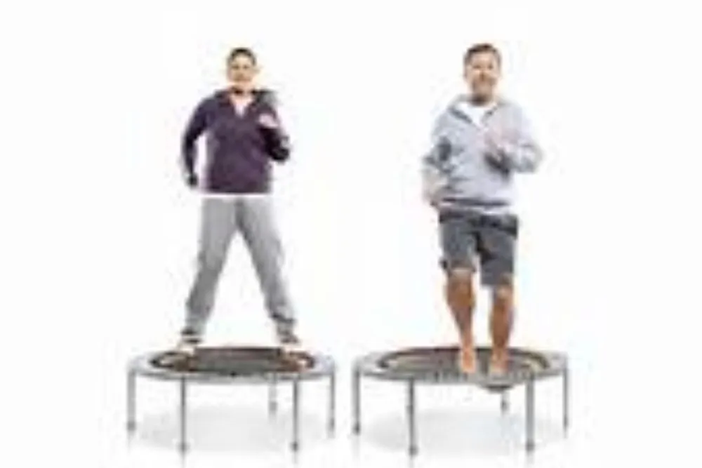 Two individuals are standing on mini trampolines with one holding a phone to his ear and both are dressed in casual attire against a white background