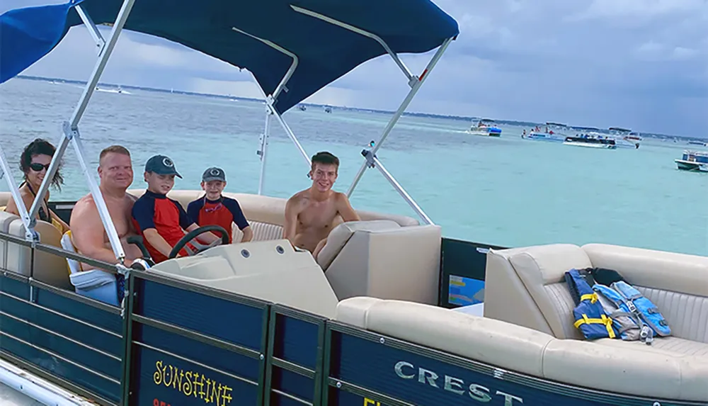 A group of people are enjoying a boat ride on a sunny day with clear turquoise waters in the background