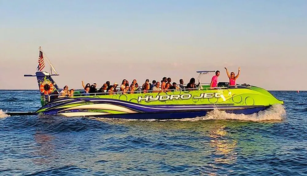A group of passengers on a vibrant green and yellow hydrojet boat appear to be enjoying a ride on the water