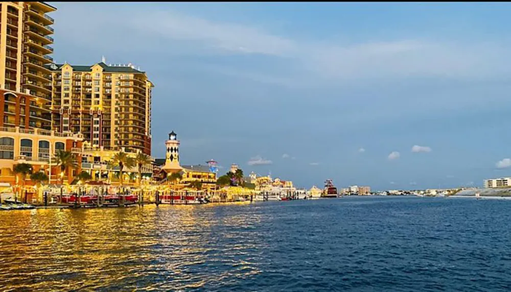 The image showcases a waterfront with a lighthouse colorful buildings and a bustling promenade under a blue sky reflecting a vibrant coastal cityscape