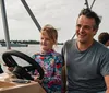 A man and a woman are enjoying a moment together on a boat chatting and smiling with a serene water backdrop