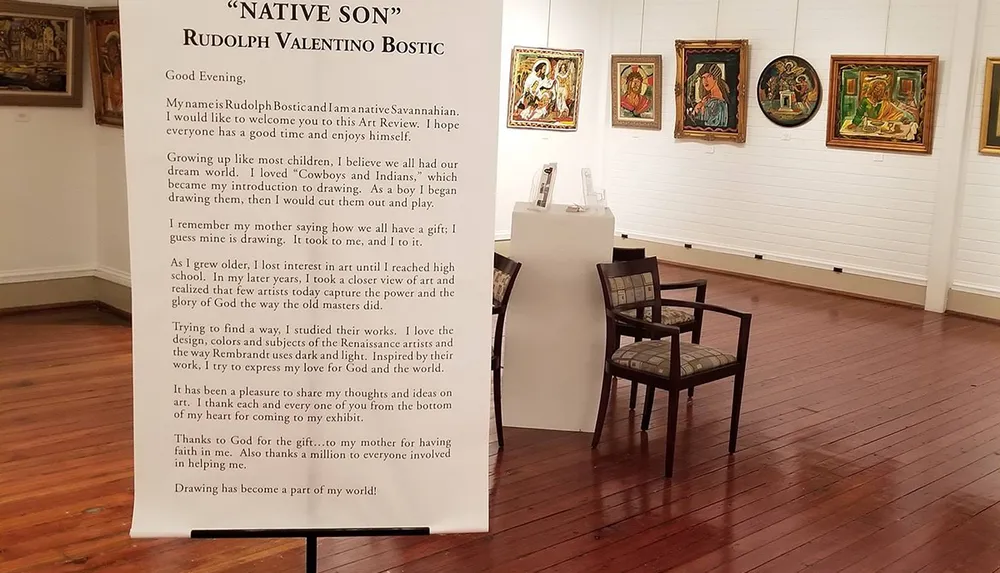 The image shows an art gallery with paintings on the wall and a statement by the artist Rudolph Valentino Bostic explaining his journey and inspiration in art