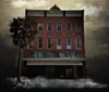 The image depicts a digitally manipulated spooky facade of an old Savannah theater with fog swirling at the entrance and a dramatic cloudy sky overlay imprinted with handwritten script creating a gothic eerie atmosphere