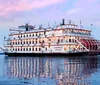 The image is a split-view showcasing two types of tourist transportation on the left is a trolley bus filled with passengers and on the right is a riverboat also carrying guests