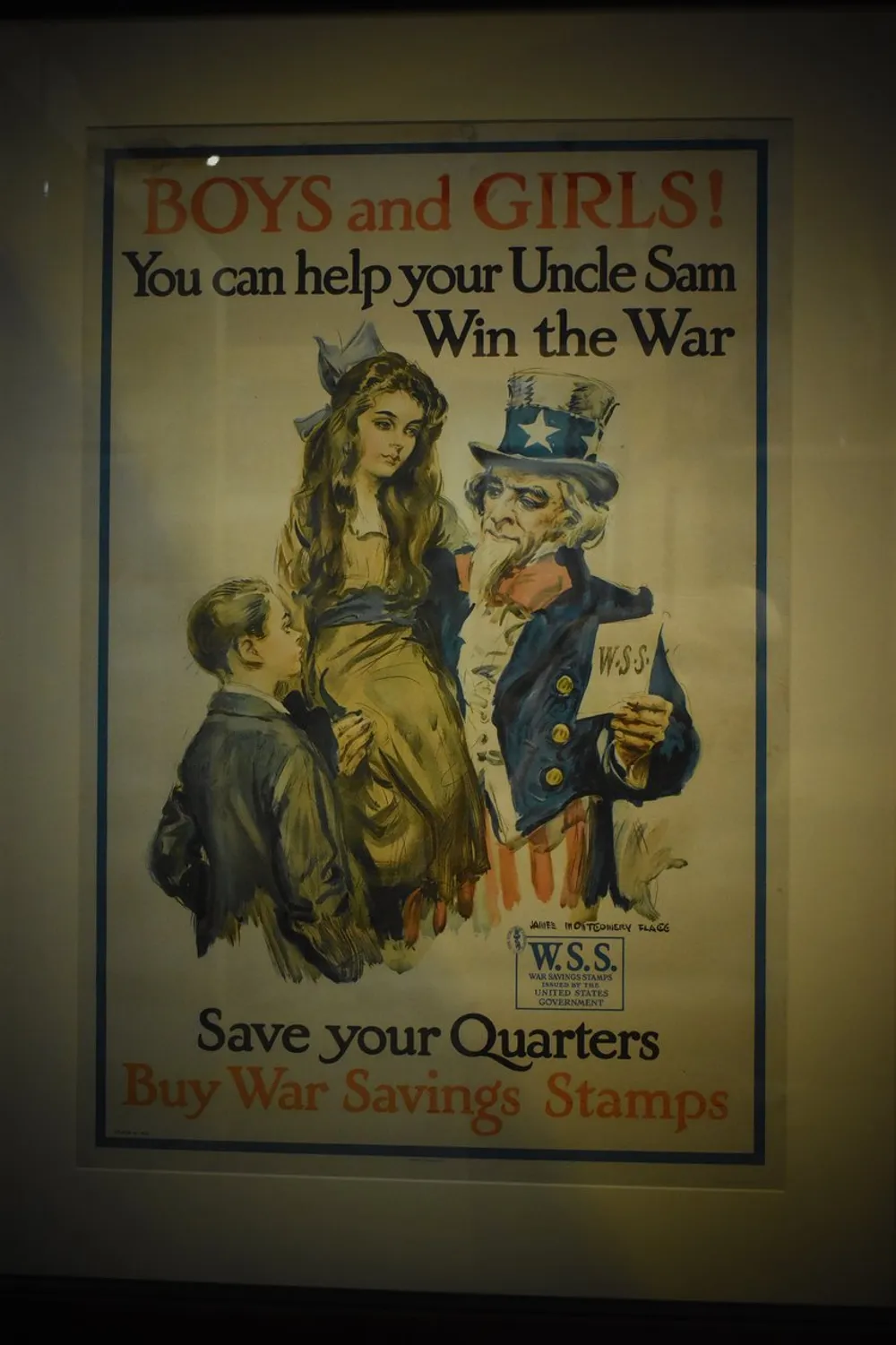 The image shows a vintage World War I-era propaganda poster encouraging boys and girls to buy War Savings Stamps to help Uncle Sam win the war illustrated with a young girl a small boy looking up to Uncle Sam who is holding a book of stamps