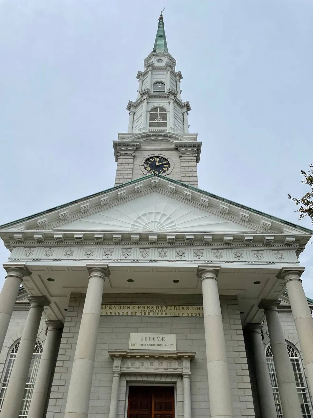 The image displays the front facade of the Independent Presbyterian Church with a prominent clock tower and classic architectural features