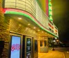The image shows a brightly lit vertical neon sign spelling Savannah above a marquee that reads LIVE ON STAGE - SAVANNAH LIVE - NOW PLAYING against a night sky
