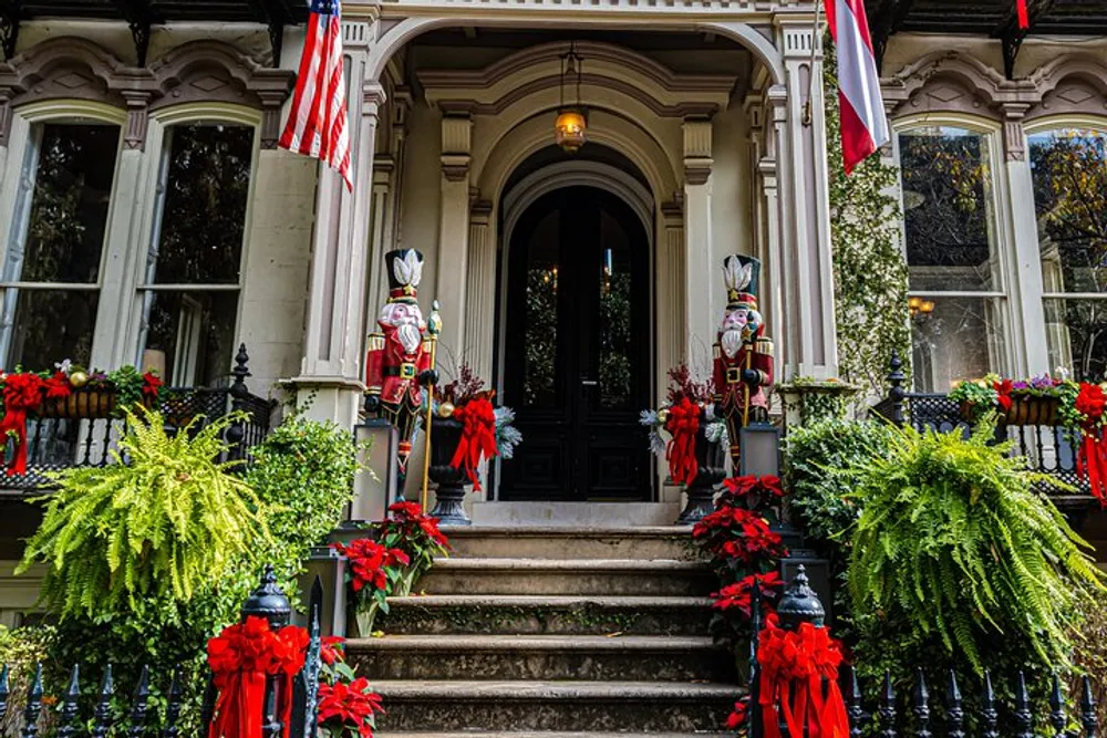 The entrance of the house is decorated festively with two large nutcracker statues American flags red bows and greenery suggesting it might be around the holiday season