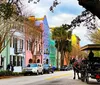 A horse-drawn carriage travels along a street lined with colorful buildings showcasing a blend of historical charm and vibrant architecture