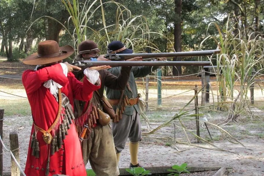 Two individuals dressed in historical clothing are aiming long rifles in an outdoor setting that suggests a historical reenactment or demonstration.