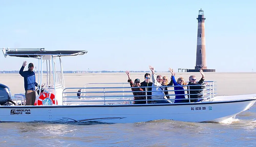 A group of people is joyfully waving from a boat with a lighthouse in the background