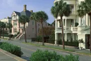 The image shows a tree-lined residential street with elegant historic homes featuring large windows, balconies and verandas, evoking a sense of Southern charm.