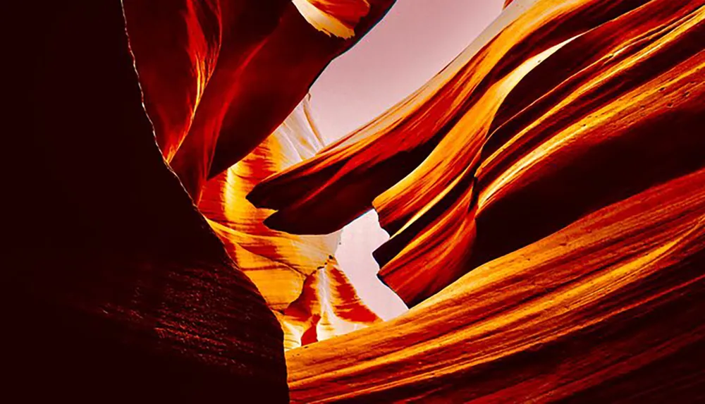 The image captures the warm swirling colors of a slot canyons rock formations illuminated by sunlight