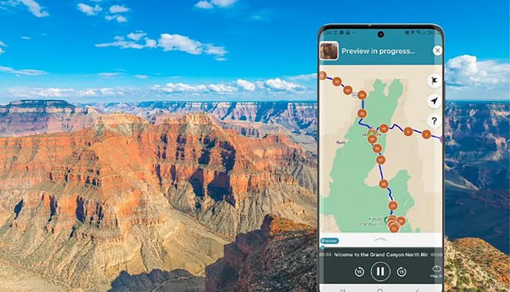 A mobile phone with a map application on its screen is superimposed on a scenic view of the Grand Canyon