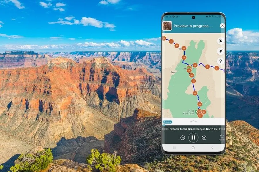 A smartphone displaying a hiking trail map is superimposed on a scenic view of the Grand Canyon.