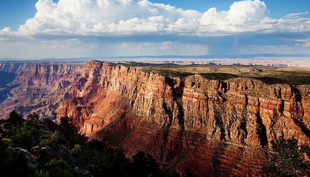 The image shows a breathtaking view of the Grand Canyon with its steep layered cliffs and a dramatic sky overhead