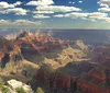 A helicopter is soaring in the sky with the picturesque backdrop of the Grand Canyon
