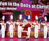 This image features a festive stage performance with a person dressed as Santa Claus dancing among performers in toy soldier costumes under a banner encouraging people to visit Santas Workshop for the Most Fun in the Dells at Christmas