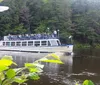 A tour boat named Chicagow is navigating between two large rock formations carrying passengers exploring a scenic waterway