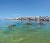 A person is snorkeling underwater near a rocky seabed captured in a photograph with a text overlay promoting FREE GoPro Videos  Pictures