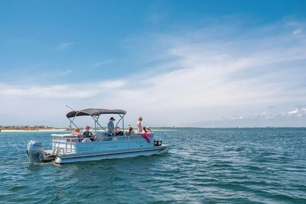 A group of individuals is enjoying a sunny day out on the sea aboard a pontoon boat