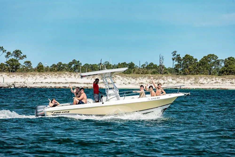 A group of people is enjoying a sunny day on a motorboat with a coastal landscape in the background